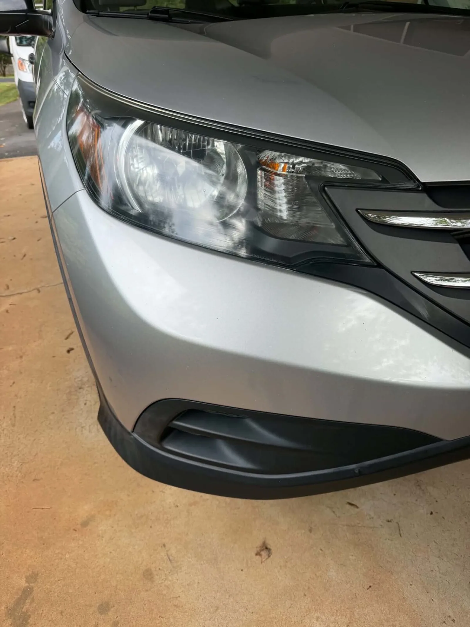 Clear, restored headlight on the same silver Honda CR-V after headlight restoration by Romeo's Detailing