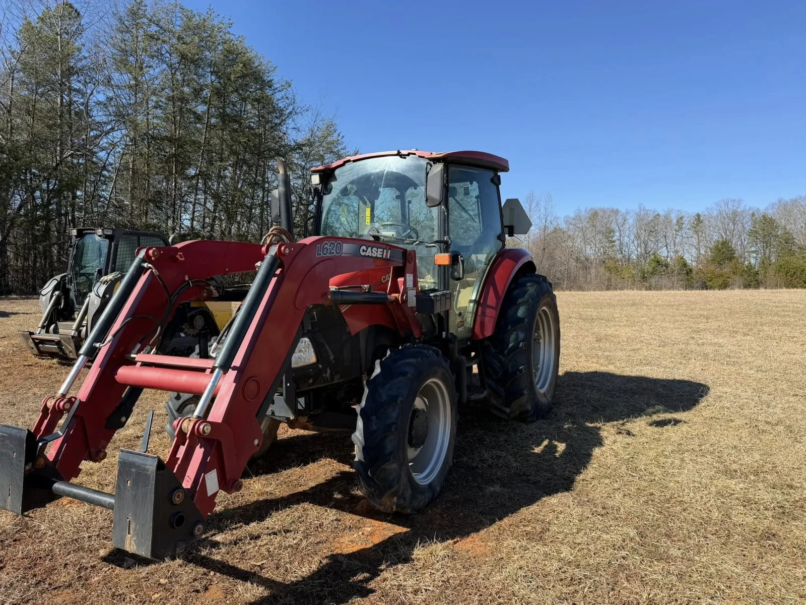 Clean red tractor with refreshed paint after mobile equipment detailing near Winston-Salem, NC