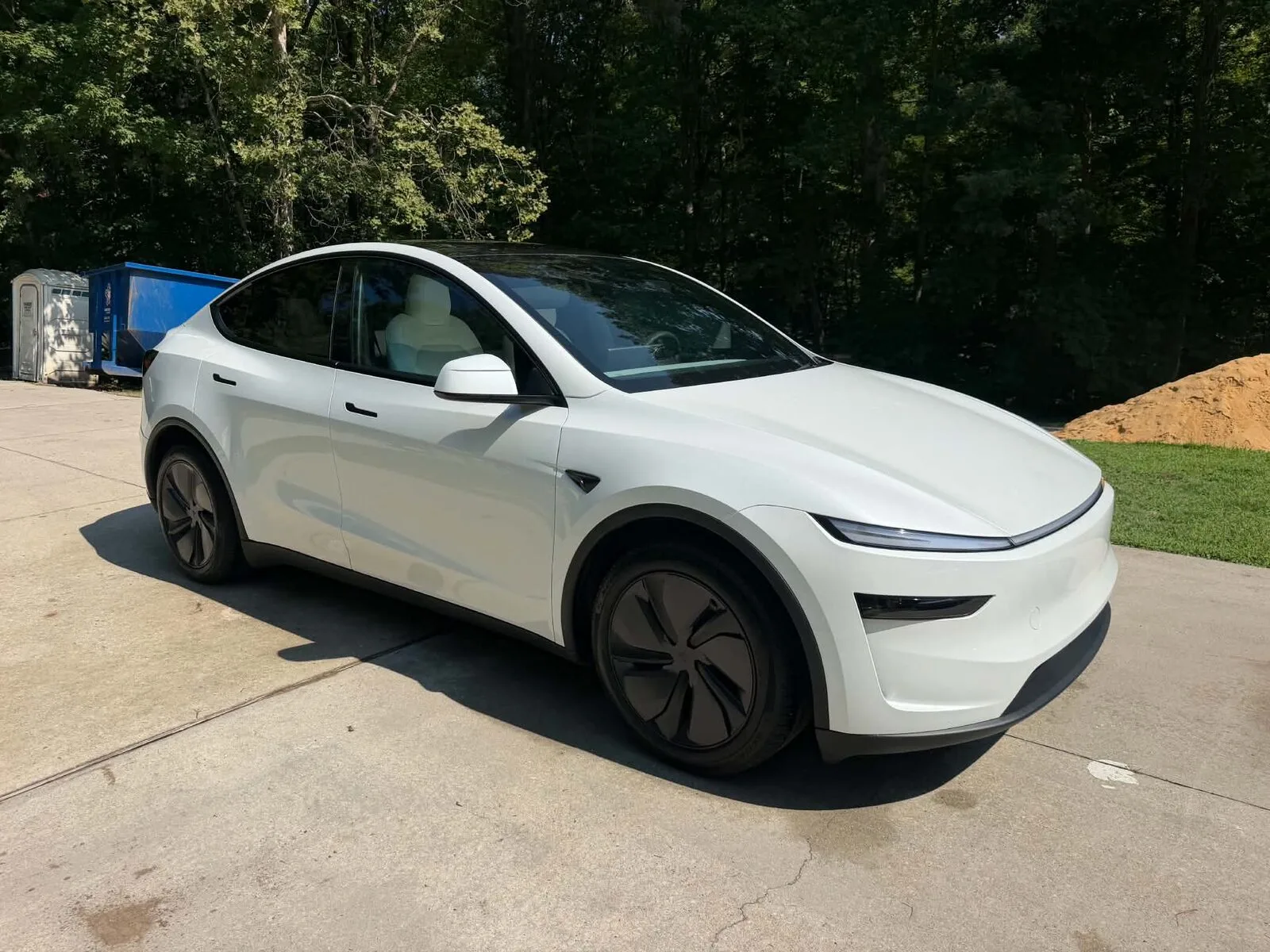 Clean white Tesla Model Y with a glossy finish after a mobile exterior detail by Romeo's Detailing