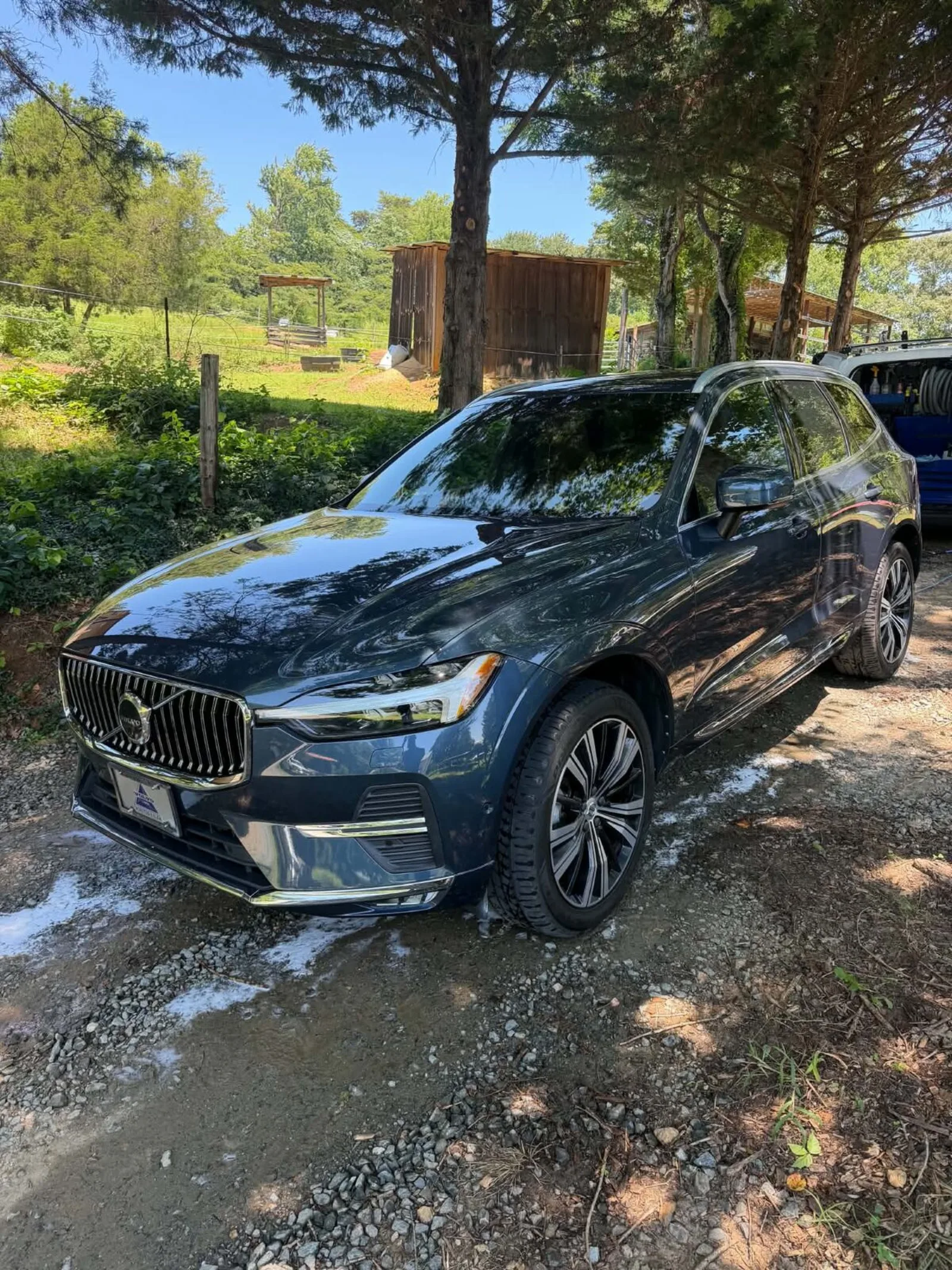 Dark blue Volvo XC60 SUV being washed and detailed outdoors by Romeo's Detailing